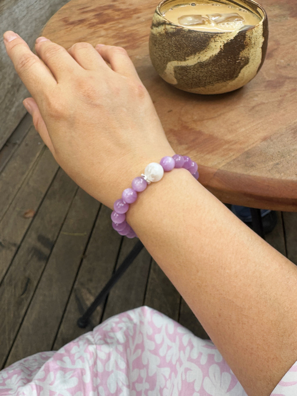 Back view of a Kunzite, Charoite & White Phantom Quartz bracelet worn on the wrist
