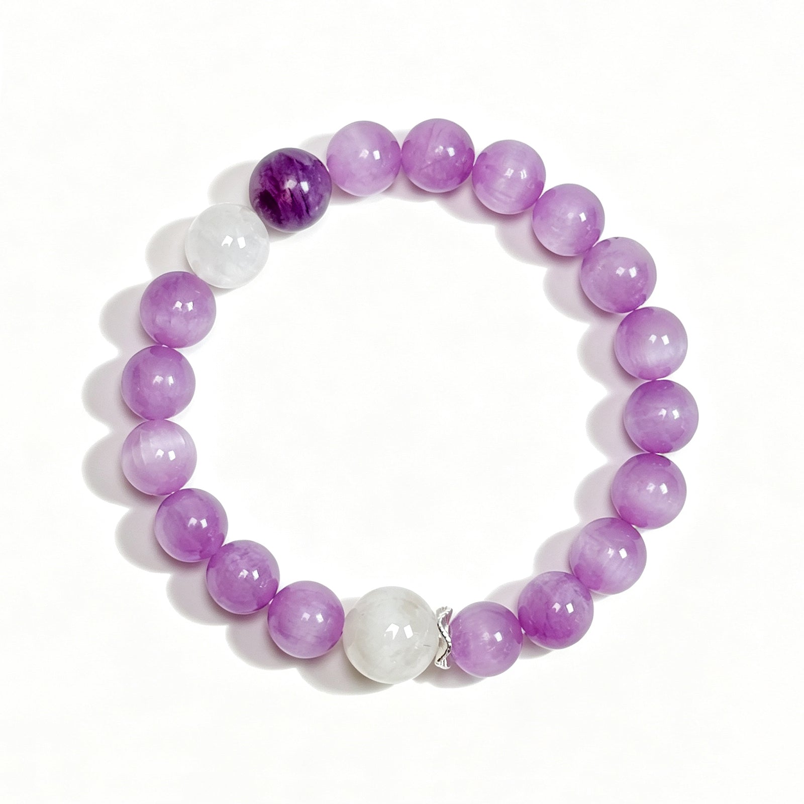 Top view of a natural Kunzite, Charoite & White Phantom Quartz bracelet showing the full bead 