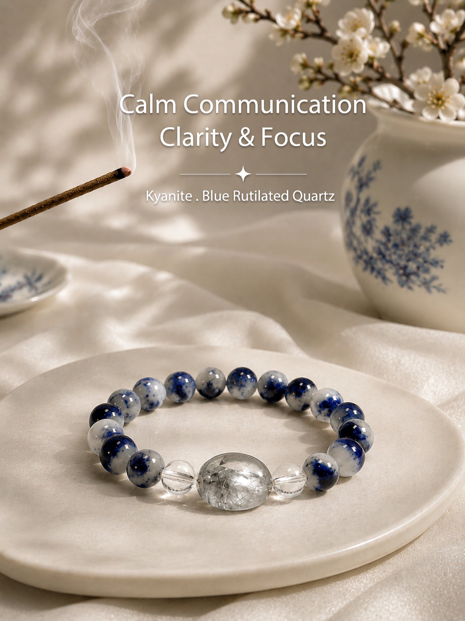 Luzzy Aura Kyanite and Blue Rutilated Quartz crystal bracelet resting beside an elegant blue-and-white porcelain vase, representing calm, clarity, and Eastern-inspired serenity.