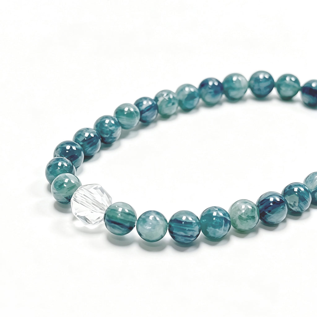 Close-up detail of Kyanite crystal bracelet showing natural blue-green stone texture