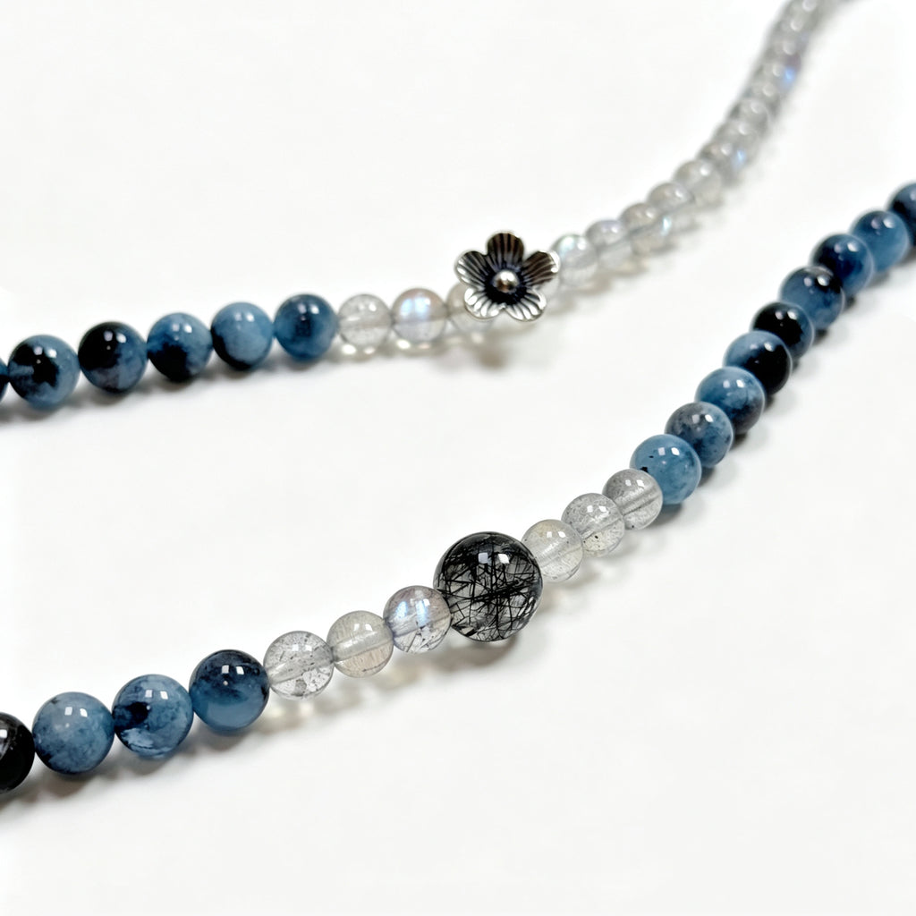 Close-up detail of labradorite, aquamarine, and black rutilated quartz bracelet showing natural crystal textures and silver accents