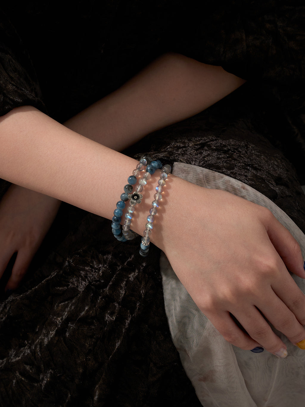 Labradorite and aquamarine wrap bracelet worn on wrist close-up showing layered blue crystal tones and calm elegant styling