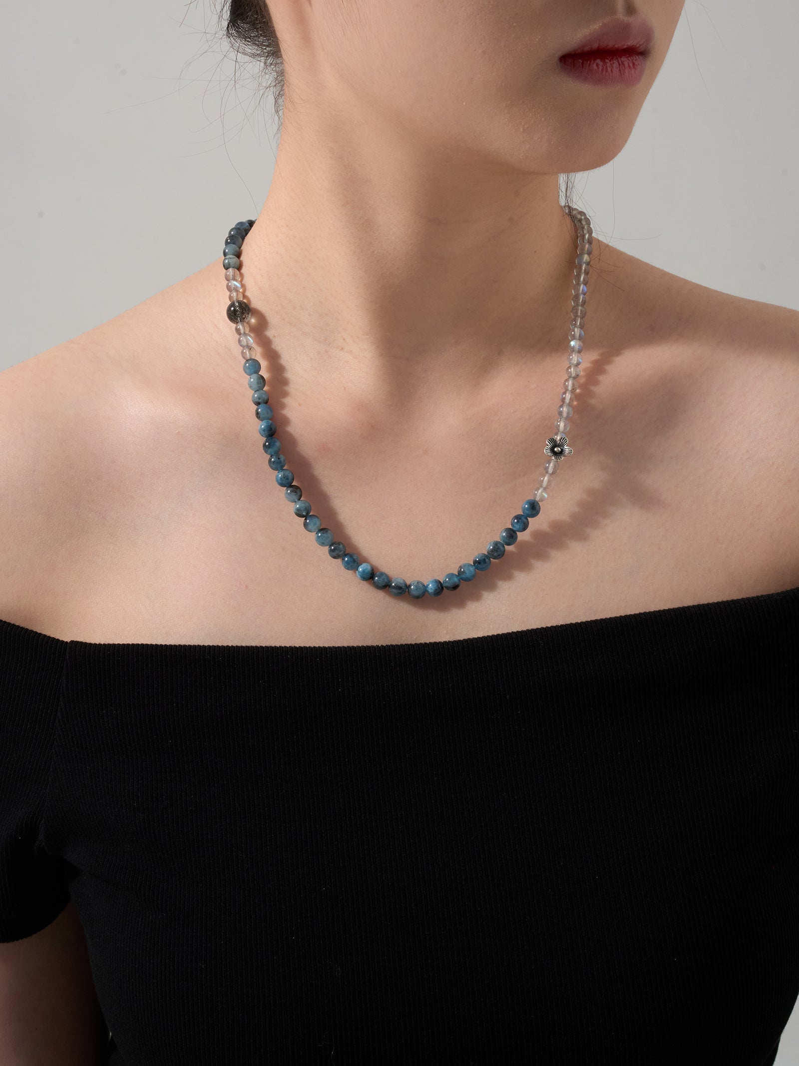 Labradorite and aquamarine wrap necklace worn as layered necklace close-up showing soft blue crystal textures and peaceful aesthetic
