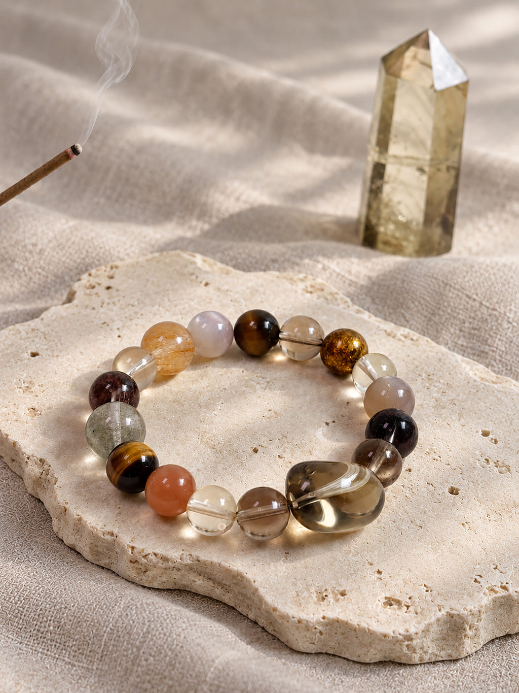 Natural Smoky Quartz, Phantom Quartz and Copper Rutilated Quartz Bracelet styled in a warm, earthy setting, highlighting its autumn-inspired colors.