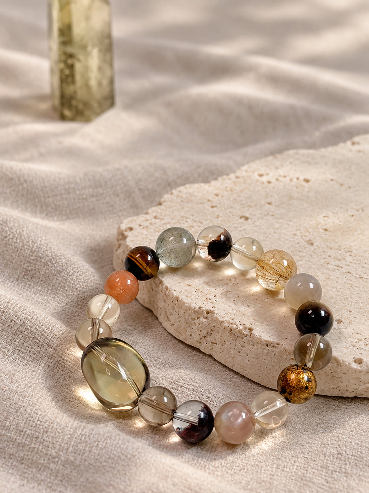 Natural Smoky Quartz, Phantom Quartz and Copper Rutilated Quartz Bracelet styled in a warm, earthy setting, highlighting its autumn-inspired colors.
