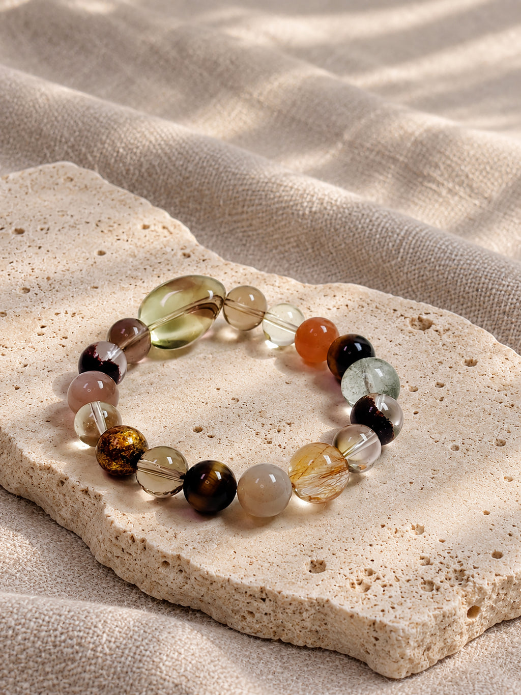 Natural Smoky Quartz, Phantom Quartz and Copper Rutilated Quartz Bracelet styled in a warm, earthy setting, highlighting its autumn-inspired colors.