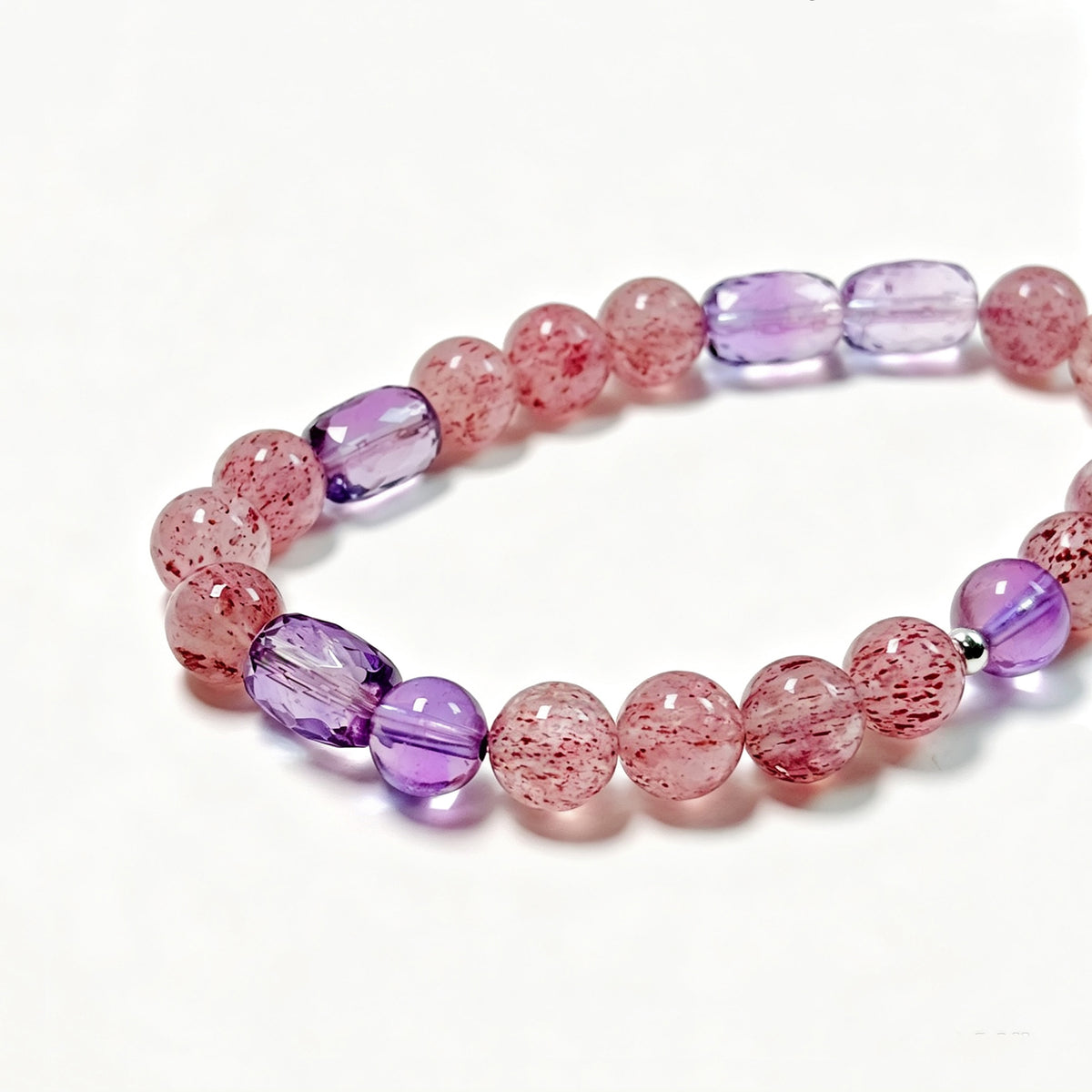  Close-up detail of natural Pale Strawberry Quartz, Amethyst and 925 Sterling Silver bracelet
