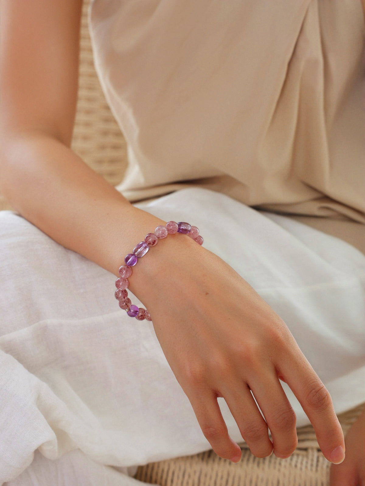 Model wearing a natural Pale Strawberry Quartz and Amethyst bracelet