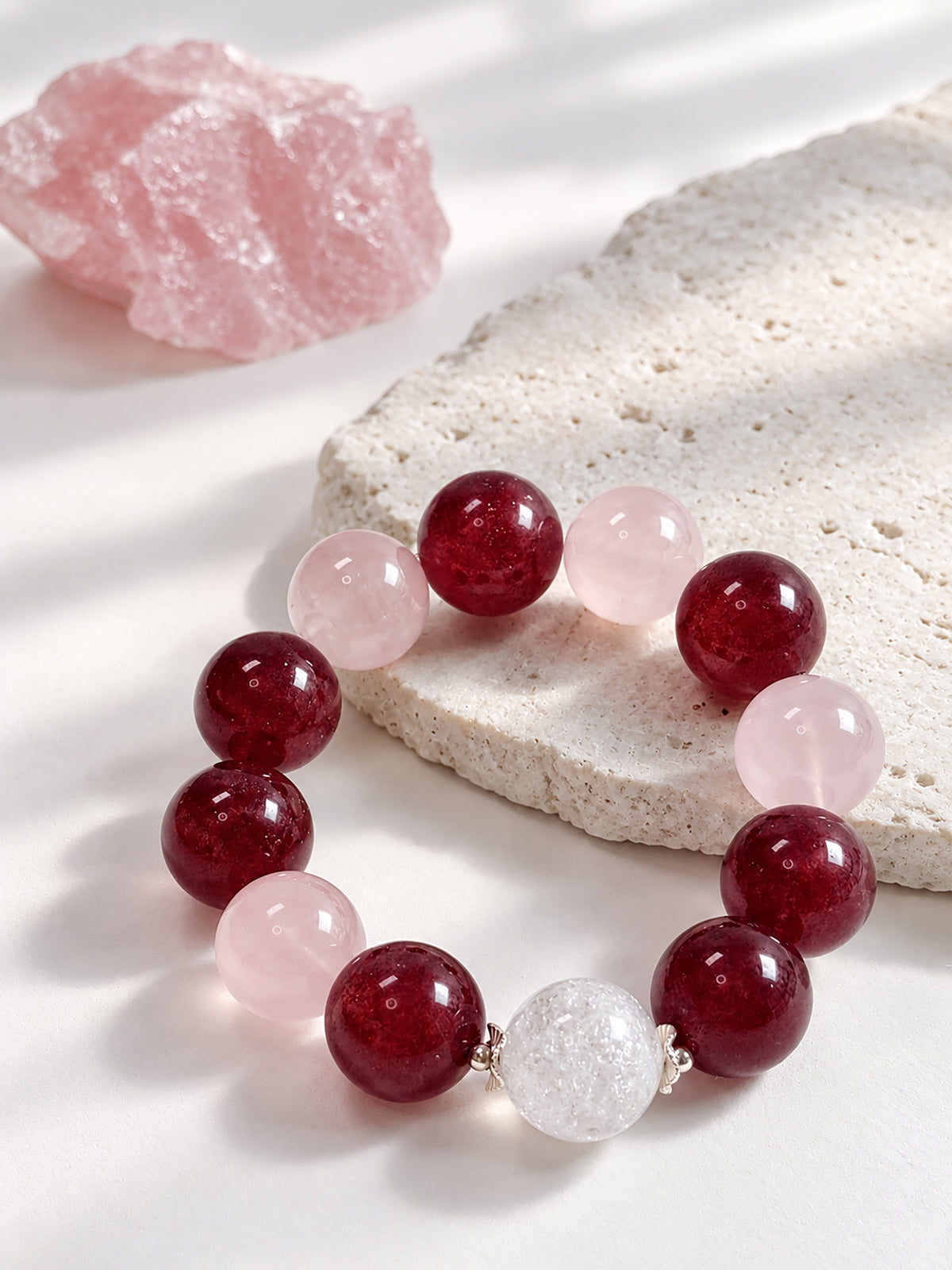 Pink Giant natural undyed Strawberry Quartz, Rose Quartz and Rainbow Clear Quartz bracelet with 925 sterling silver in a refined lifestyle setting.