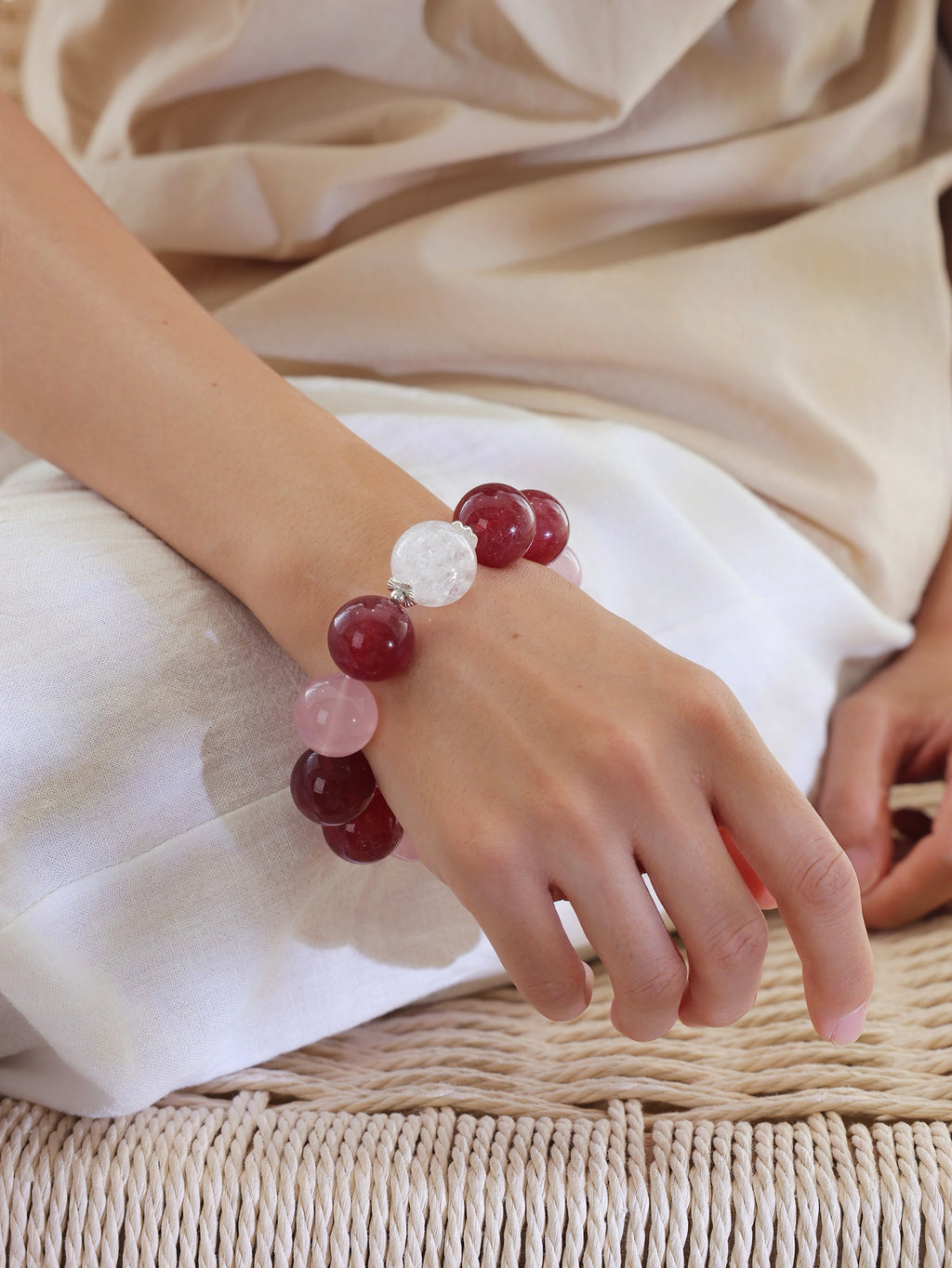Model wearing the Pink Giant natural undyed Strawberry Quartz, Rose Quartz and Rainbow Clear Quartz bracelet with 925 sterling silver and approximately 18mm beads.