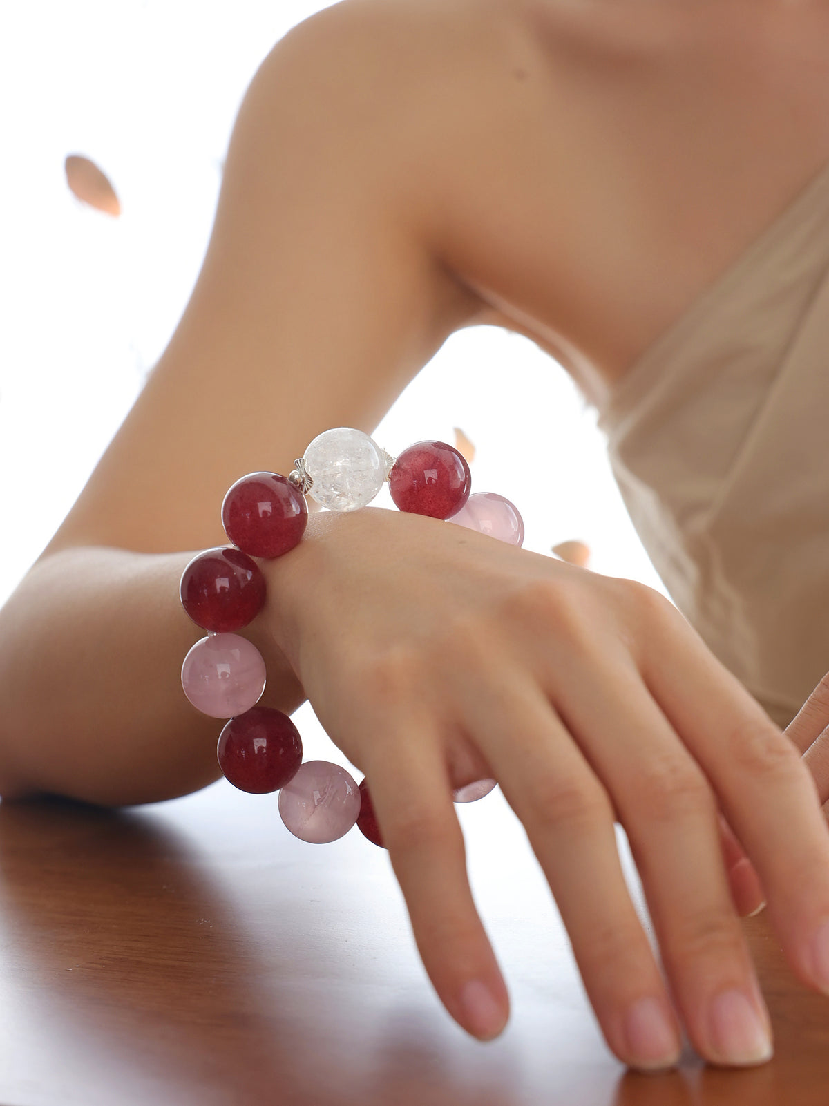 Model wearing the Pink Giant natural undyed Strawberry Quartz, Rose Quartz and Rainbow Clear Quartz bracelet with 925 sterling silver and approximately 18mm beads.