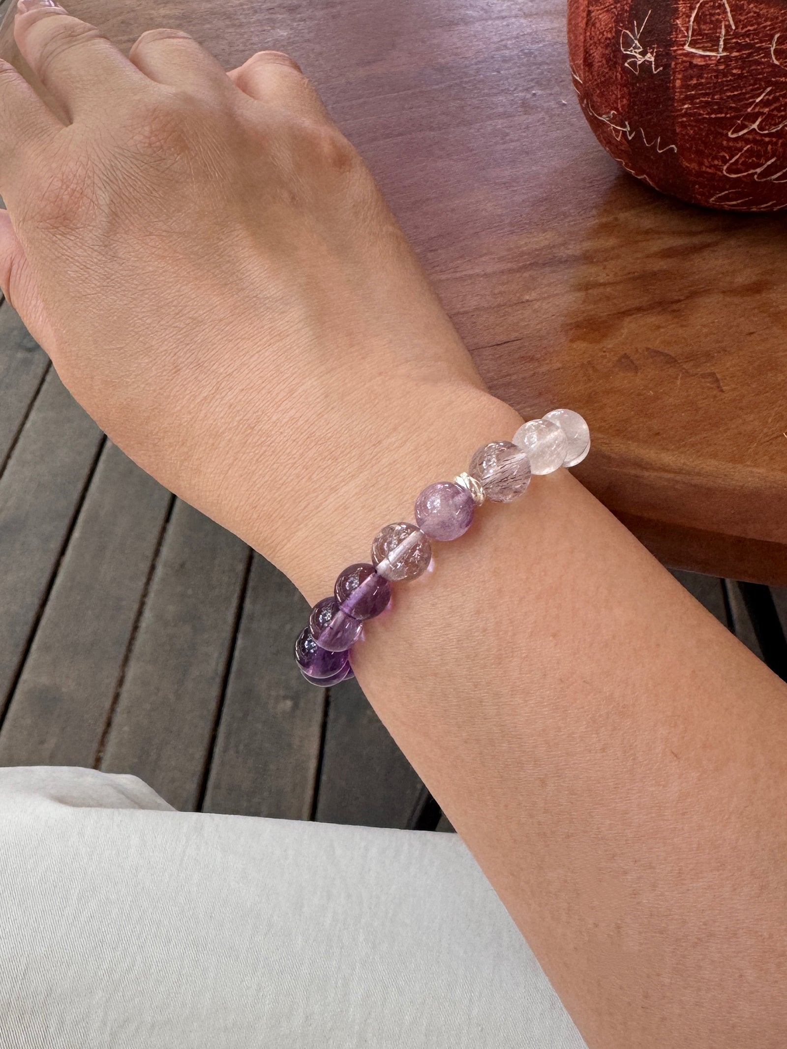 Purple rutilated quartz, amethyst, and moonstone bracelet showing the alternate side of the detailed bead arrangement on wrist