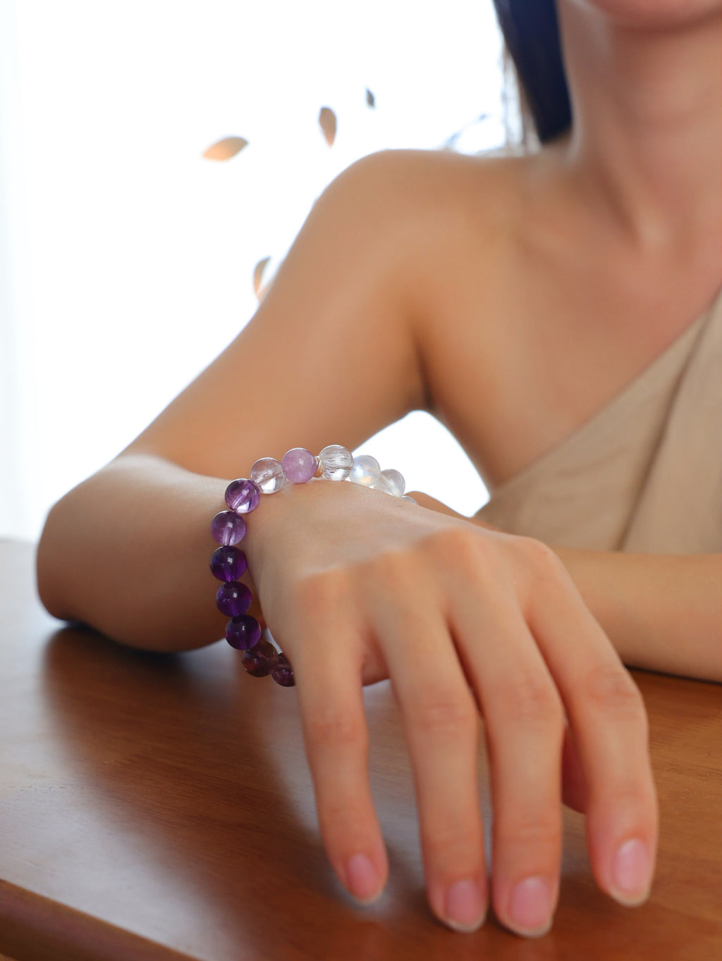 Model wearing a natural Purple Super Seven, Purple Titanium Quartz, Amethyst and Moonstone bracelet