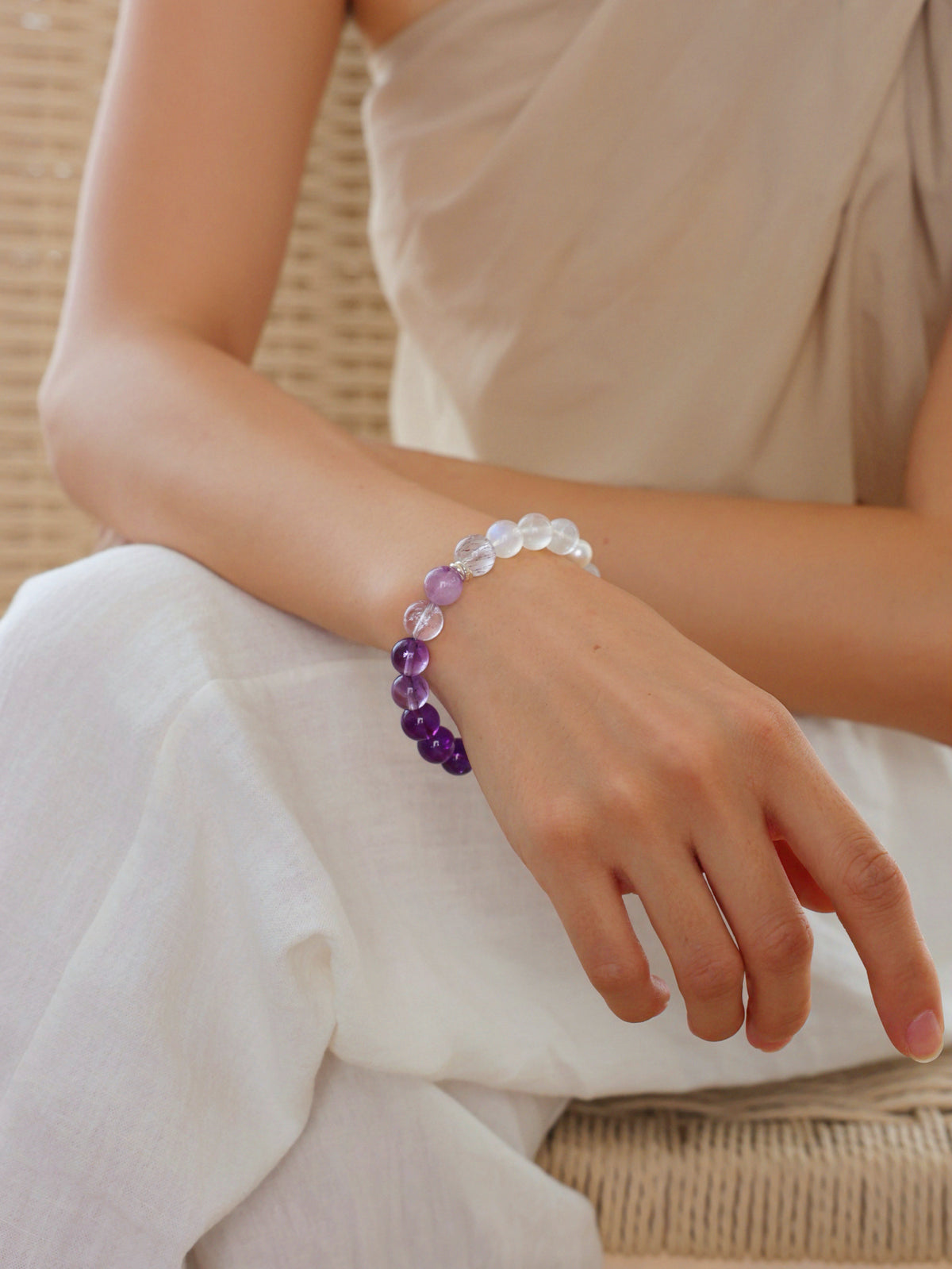 Model wearing a natural Purple Super Seven, Purple Titanium Quartz, Amethyst and Moonstone bracelet