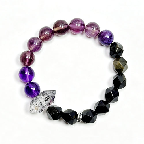 Top view of purple titanium quartz, amethyst, and obsidian bracelet showing full bead arrangement and crystal point details