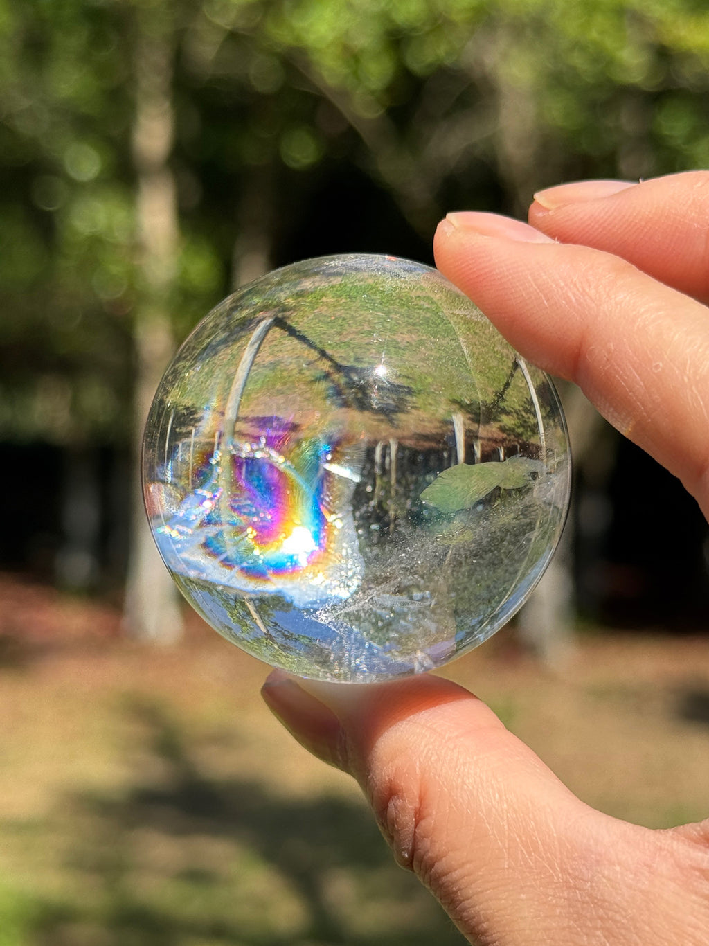 Close-up of natural rainbow inclusions inside a clear quartz sphere