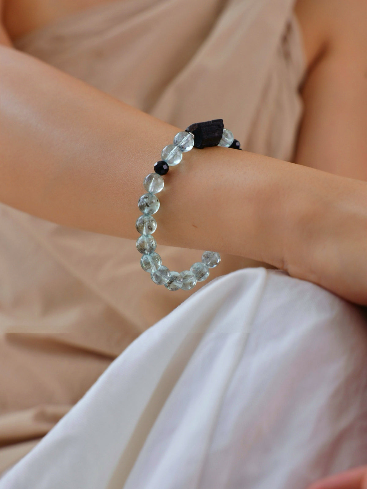 Rare green Aquamarine, Black Tourmaline and Black Spinel bracelet worn on wrist