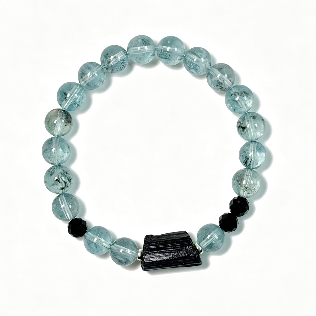 Top view of rare green-toned Aquamarine bracelet with raw Black Tourmaline and Black Spinel