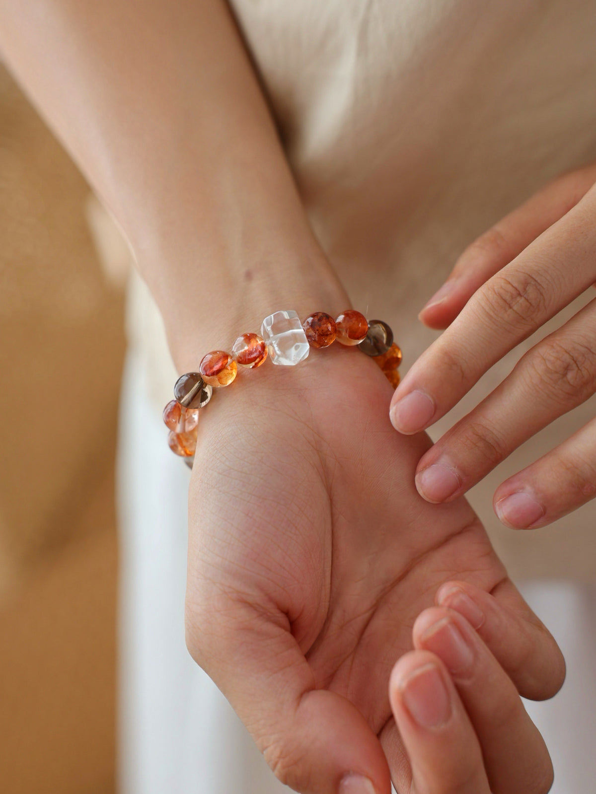 Red Flower Quartz, Silver Rutilated Quartz and Smoky Quartz bracelet worn on wrist