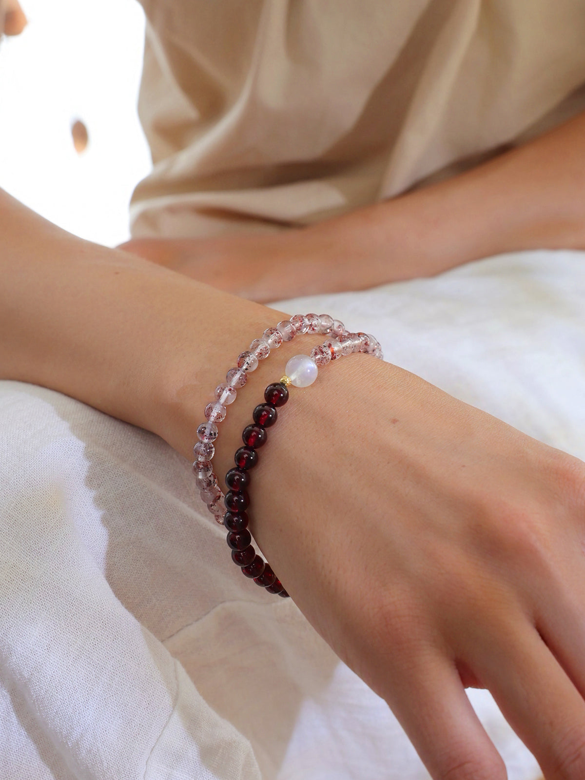 Close-up of a double-wrap Red Super Seven Quartz and Garnet bracelet on the wrist, highlighting its vintage-inspired design and delicate gemstone details.