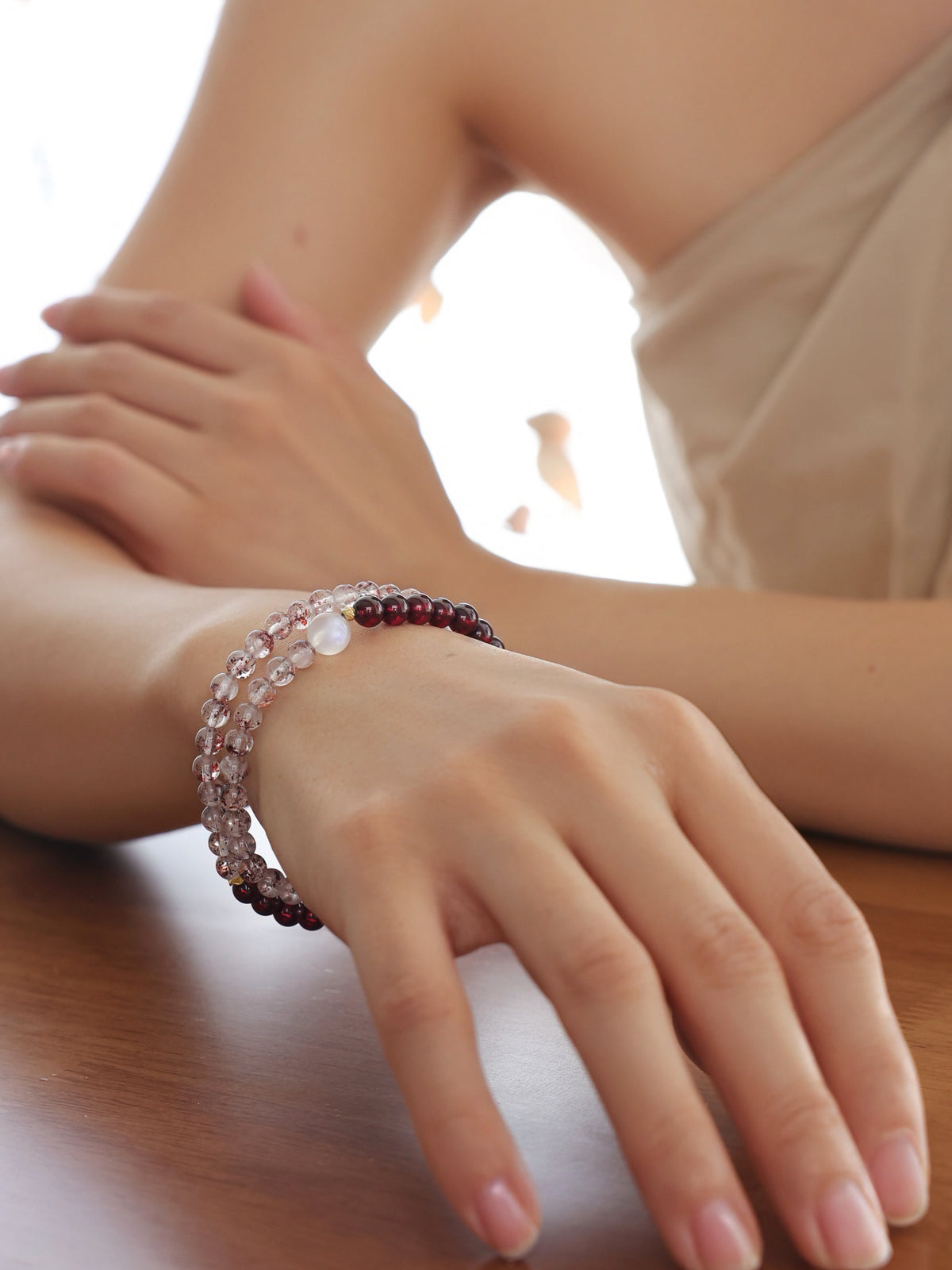 Close-up of a double-wrap Red Super Seven Quartz and Garnet bracelet on the wrist, highlighting its vintage-inspired design and delicate gemstone details.