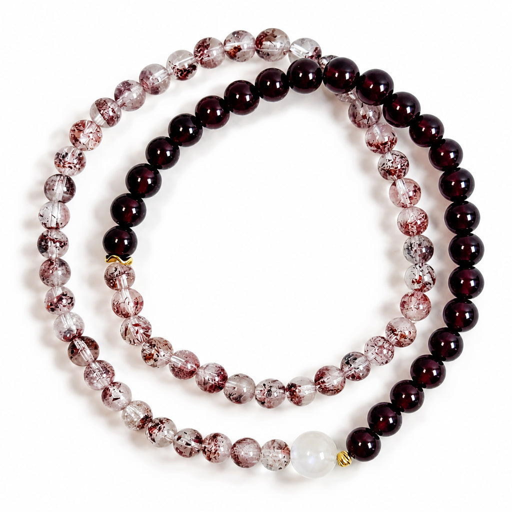 Natural Red Super Seven Quartz, Garnet and Moonstone double-wrap bracelet with gold-plated sterling silver, photographed from above on a white background.