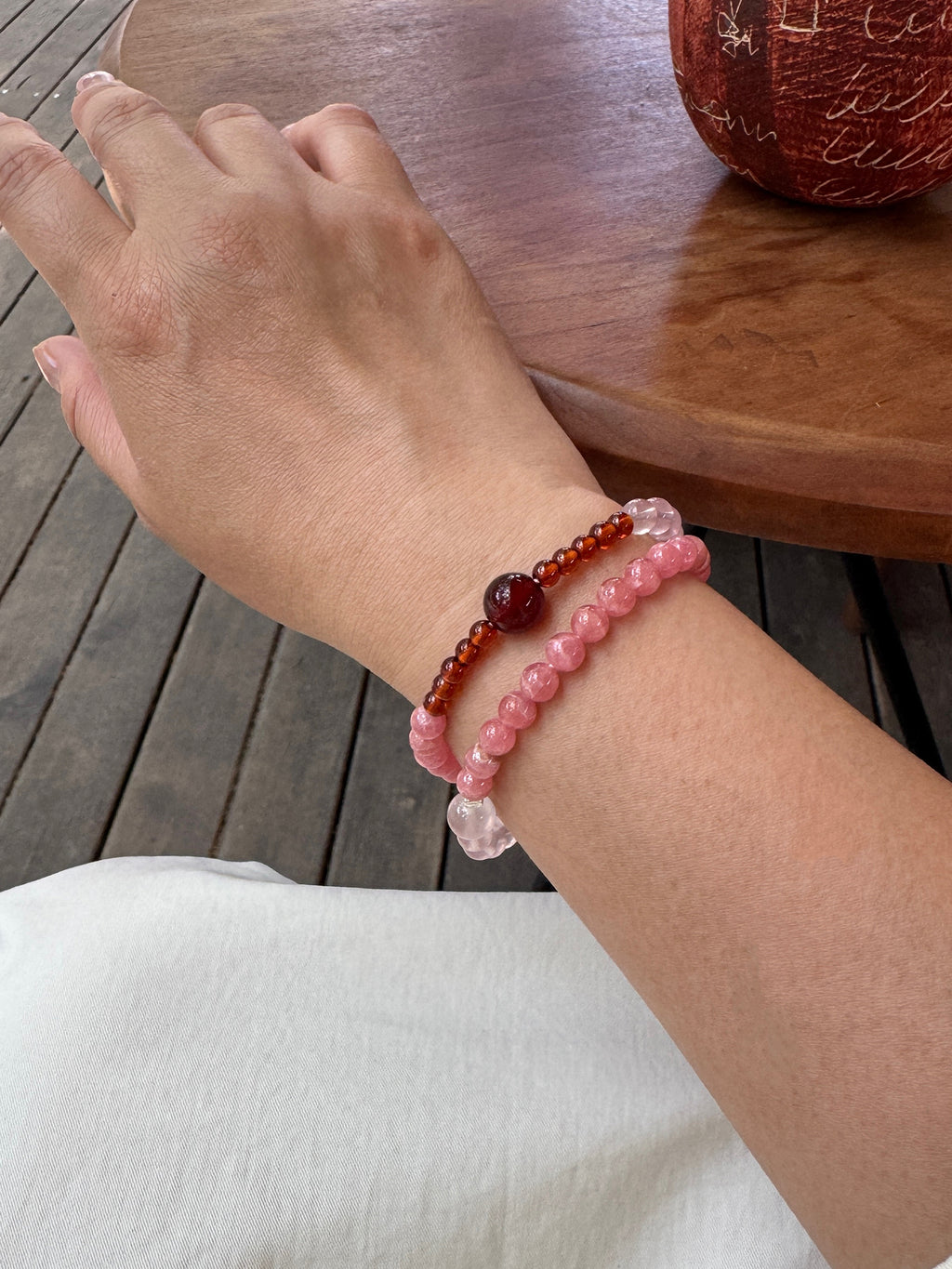 Rhodochrosite and Star Rose Quartz bracelet worn on wrist close-up showing natural texture and fit
