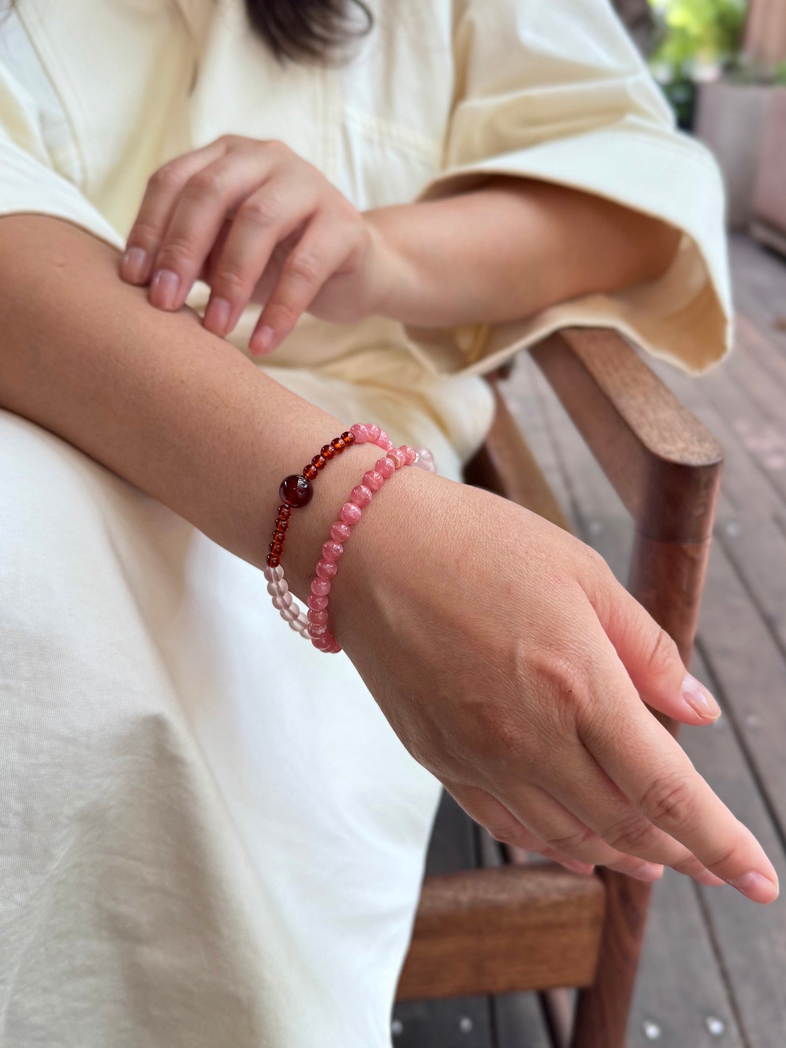 Rhodochrosite and Star Rose Quartz bracelet worn naturally in a soft feminine lifestyle setting