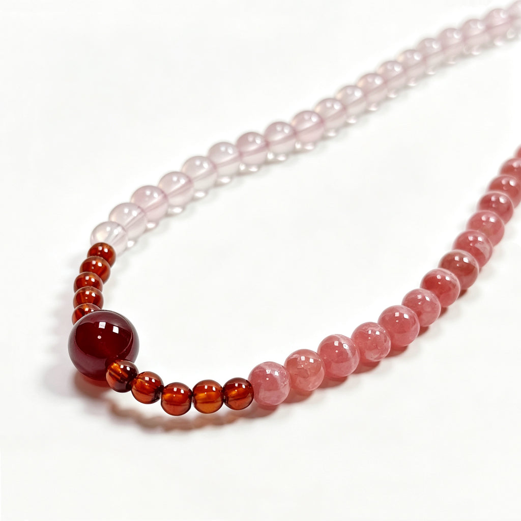 Close-up detail of Rhodochrosite and Star Rose Quartz bracelet showing natural crystal texture