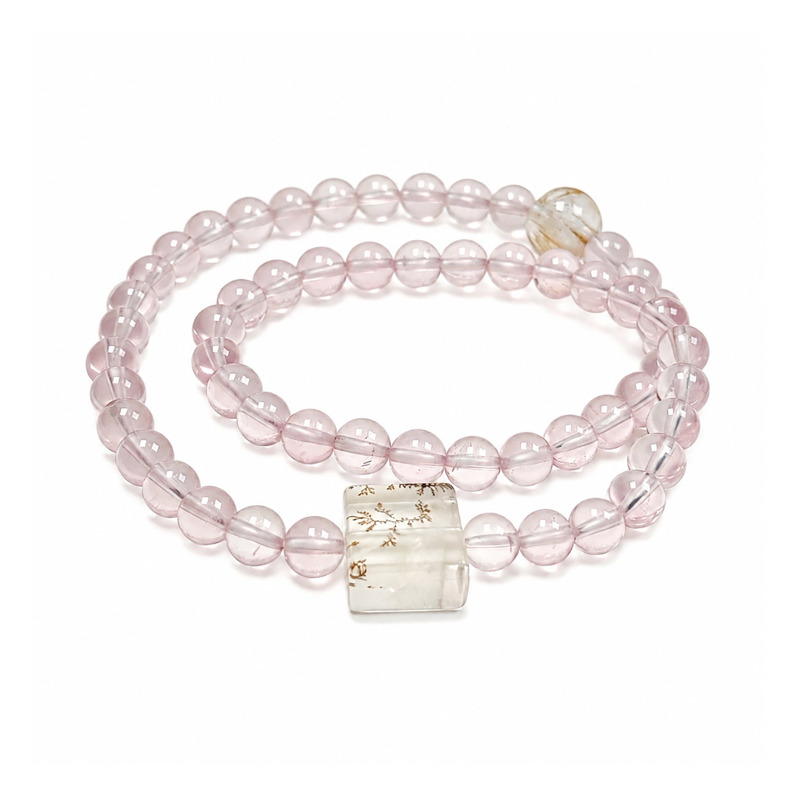 Rose quartz bracelet on clean white background for love and self-love
