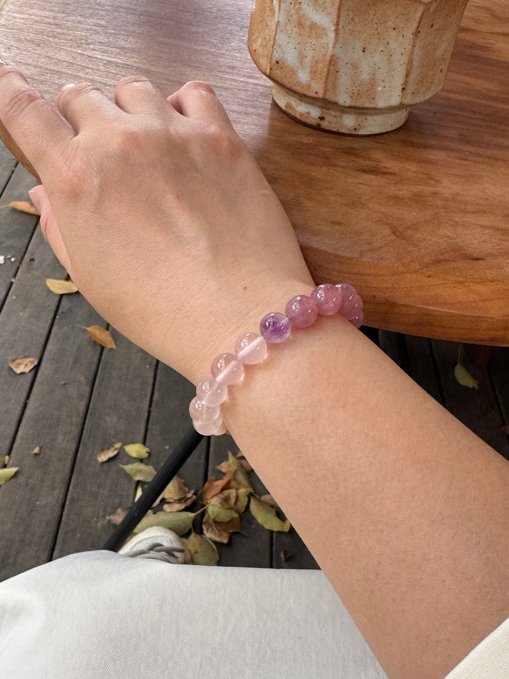 Rose quartz crystal bracelet worn on wrist close-up for love and emotional connection
