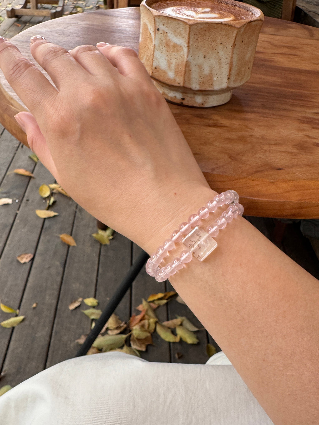 Rose quartz crystal bracelet worn on wrist close-up for love and emotional connection