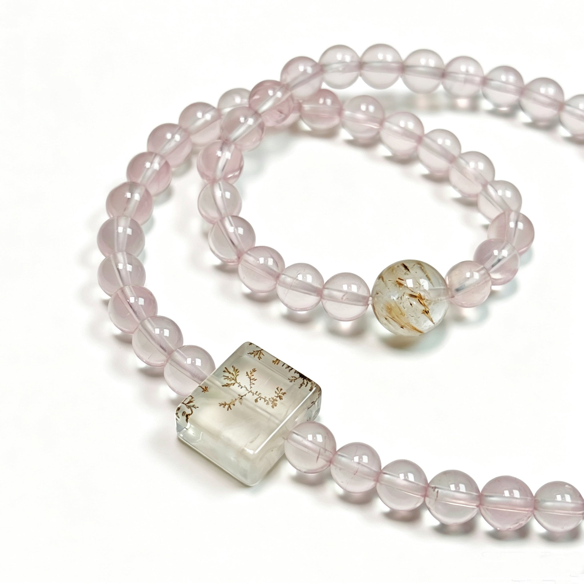 Close-up detail of rose quartz crystal bracelet showing natural stone texture for self-love and gentle emotional healing
