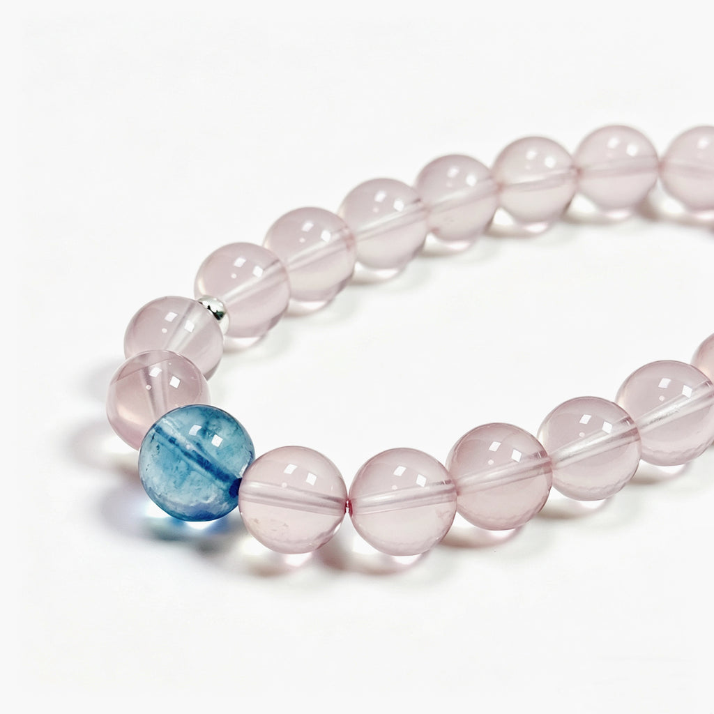 Close-up detail of rose quartz crystal bracelet showing natural stone texture for self-love and gentle emotional healing

