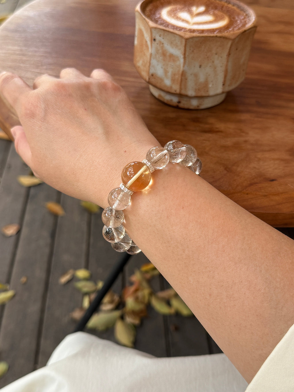 Silver Rutilated Quartz manifestation crystal bracelet worn on wrist close-up showing size and fit