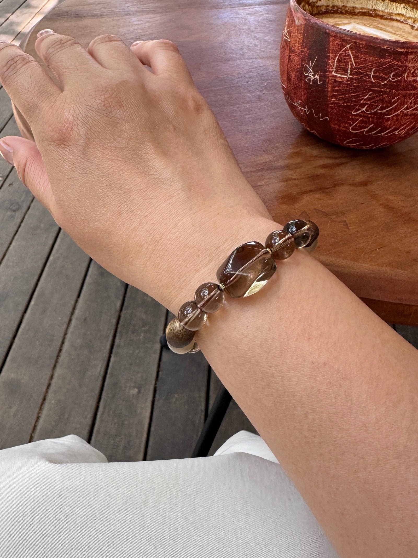 Smoky quartz bracelet showing one side of the natural layered design on wrist