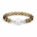 Smoky quartz bracelet with white phantom quartz focal bead on clean white background for grounding and stability