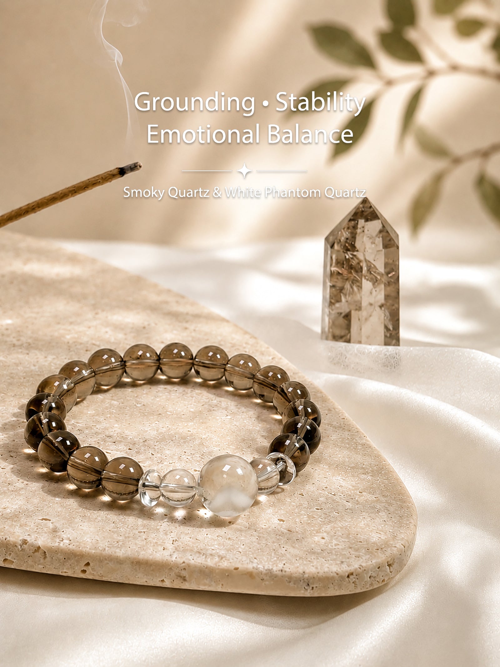 Smoky quartz and white phantom quartz bracelet styled on meditation altar for grounding and calm energy