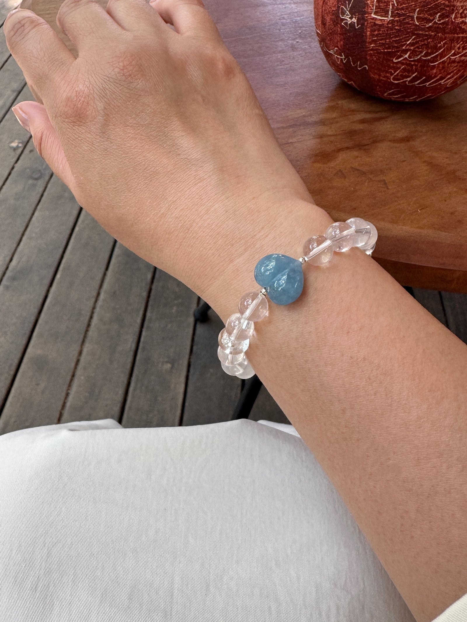 Snow Strawberry Quartz bracelet worn on wrist close-up showing natural crystal texture and fit