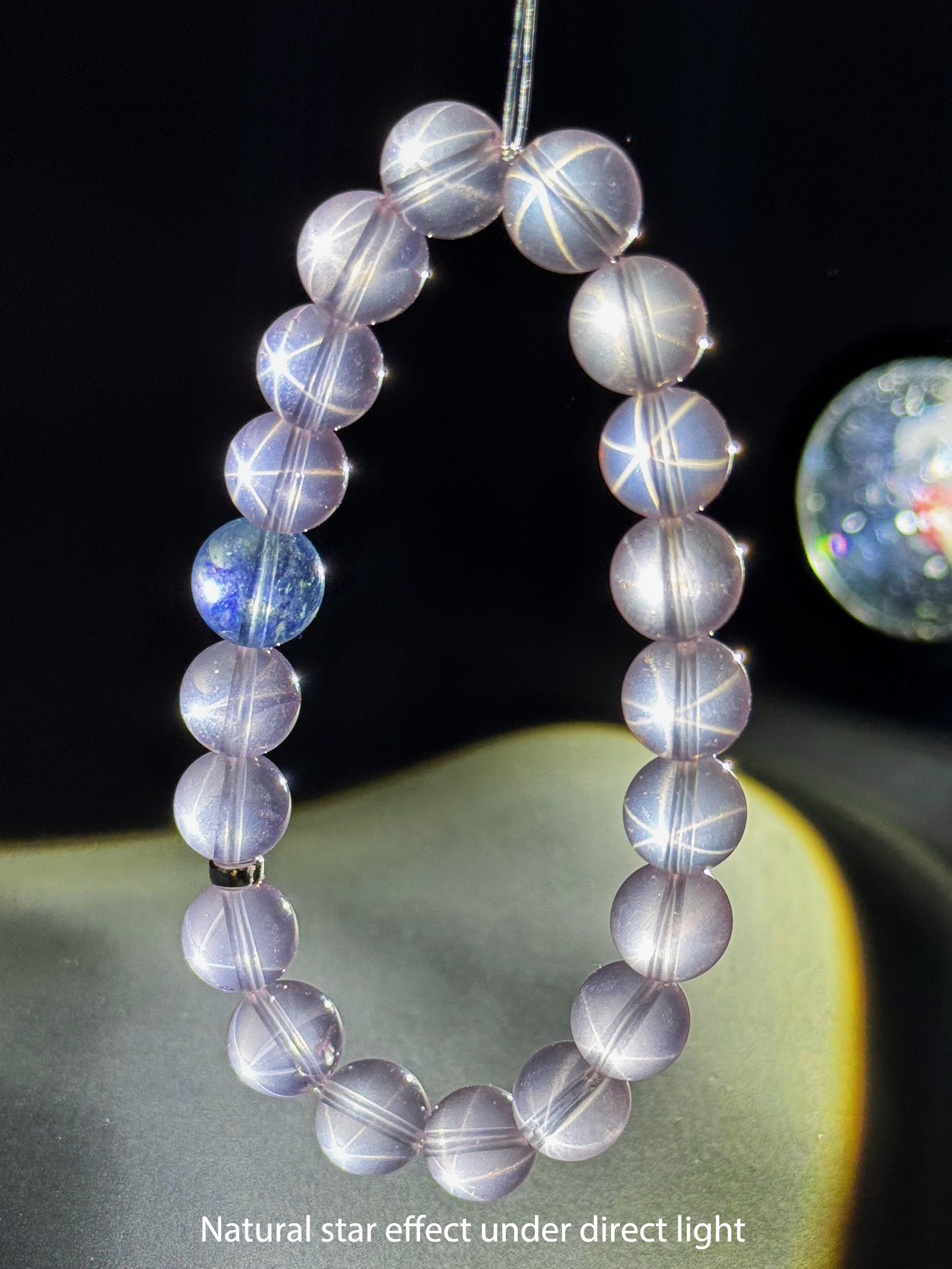 Star Rose Quartz bracelet showing its natural star effect under focused direct lighting
