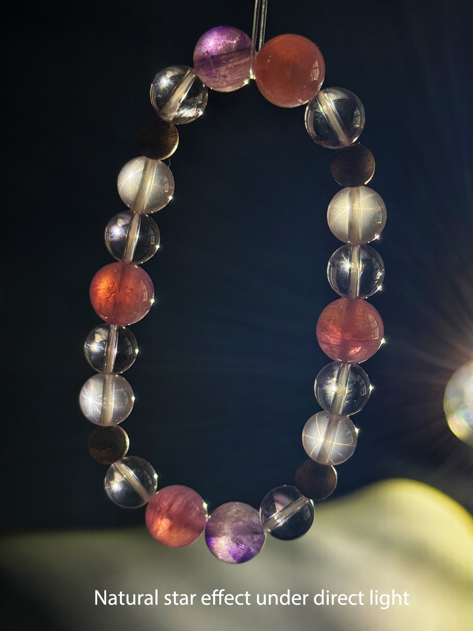 Star Rose Quartz bracelet showing its natural star effect under focused direct lighting